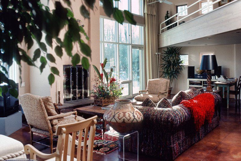 A living room with a couch and chairs and a fireplace