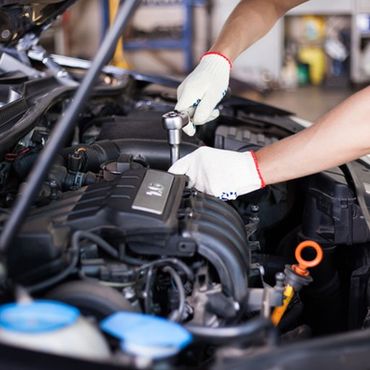Hands of a Car Mechanic on Motor — Lino Lakes, MN — Schelen-Gray Auto & Electric Hands of a Car Mechanic on Motor — Lino Lakes, MN — Schelen-Gray Auto & Electric