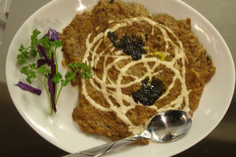 A plate of food with a spoon on it