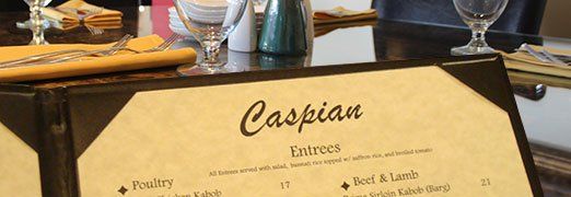 A close up of a caspian menu on a table