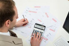 Businessman computing expenses | Lenway Law Office - Austin, MN