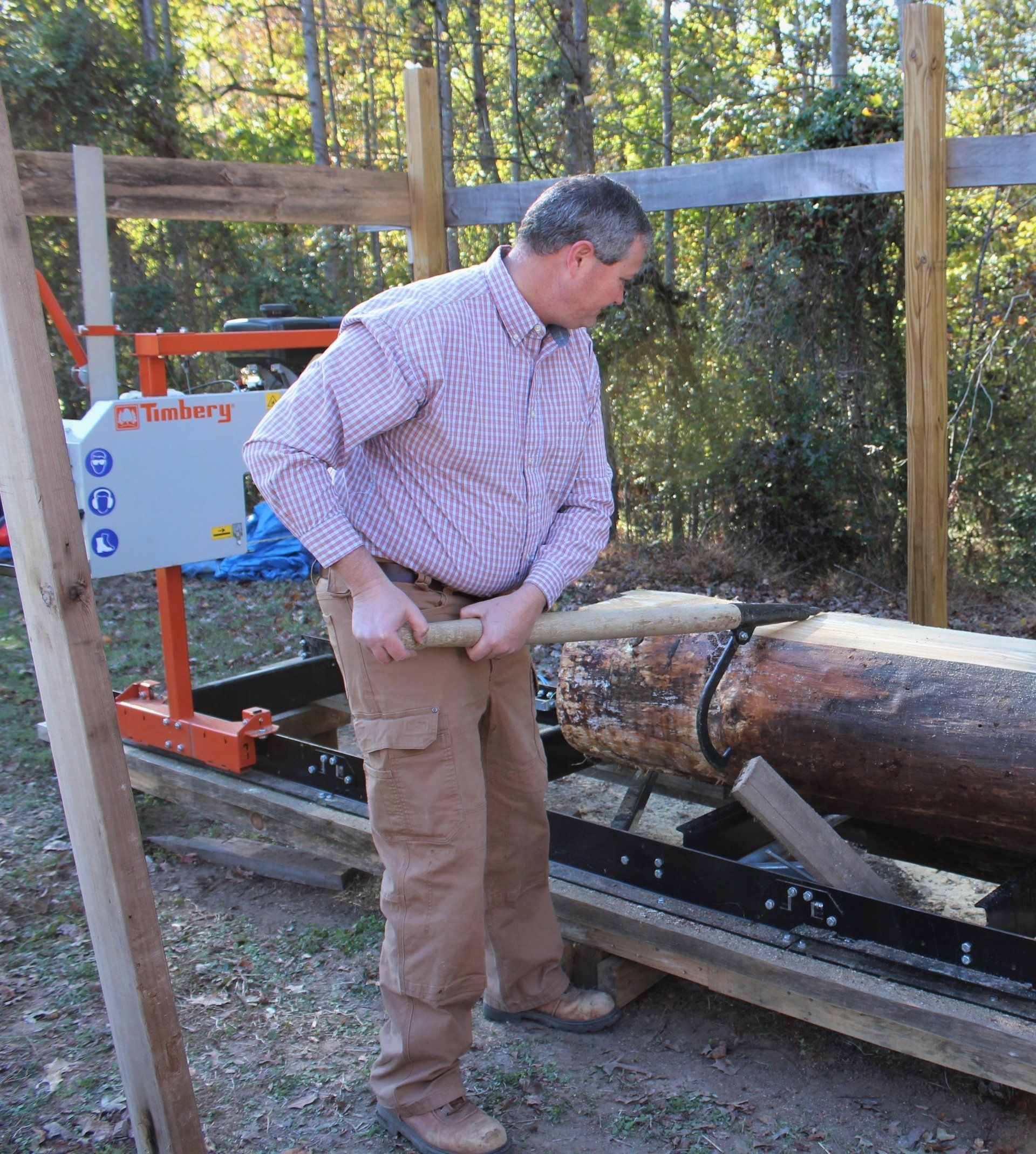 Hobby farmer adjusting trunk position using a log turner on Timbery M100