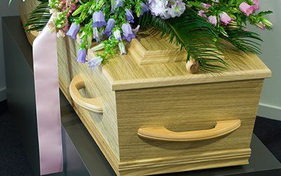 a customised coffin decorated with flowers