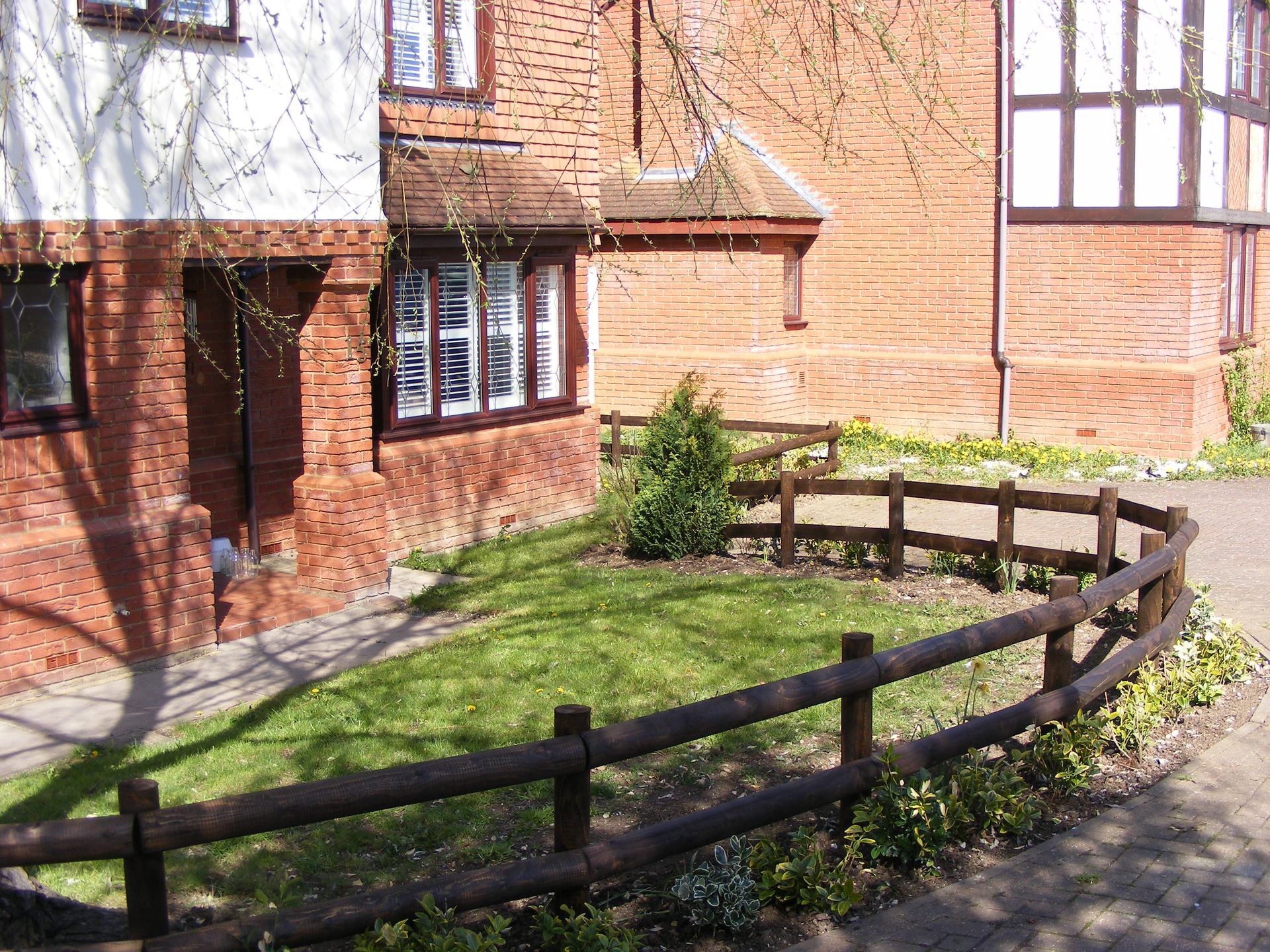 Front of house with garden and fence