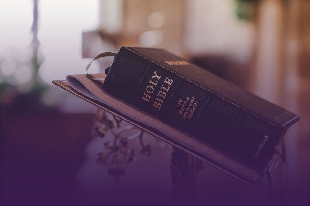 Black Bible on a book stand with