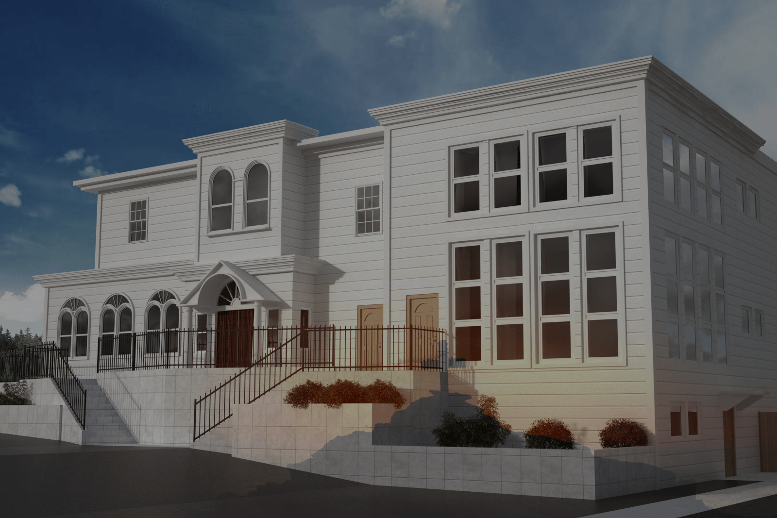 White multi-story building with multiple windows, arched entryway, and staircase.