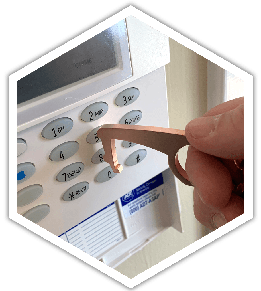 A person is using a keychain to open a security system.