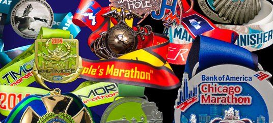 A bunch of medals are sitting on top of each other on a table.