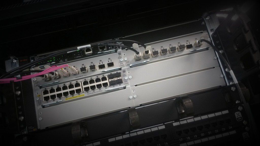 Close-up of a network switch and patch panel with multiple Ethernet ports and connected cables