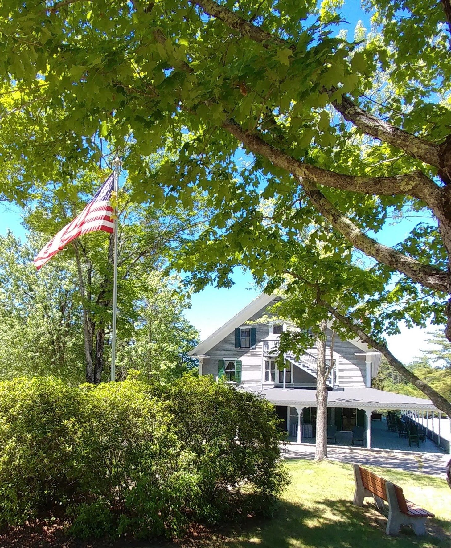 An american flag is flying in front of a house