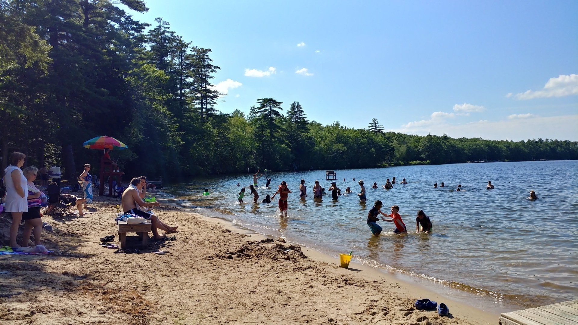 A group of people are playing in the water at a beach
