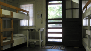 A room with bunk beds and a door that is open