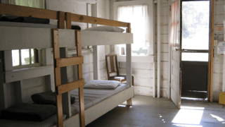 A room with bunk beds and a door that is open