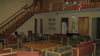 A living room with a lot of furniture and a staircase