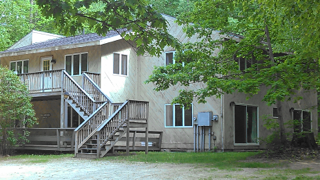 A large house with stairs leading up to the second floor