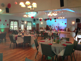 A large room with tables and chairs set up for a party