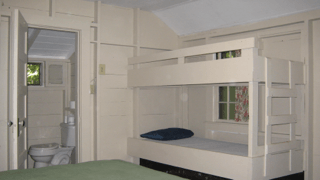 A bedroom with a bunk bed and a toilet