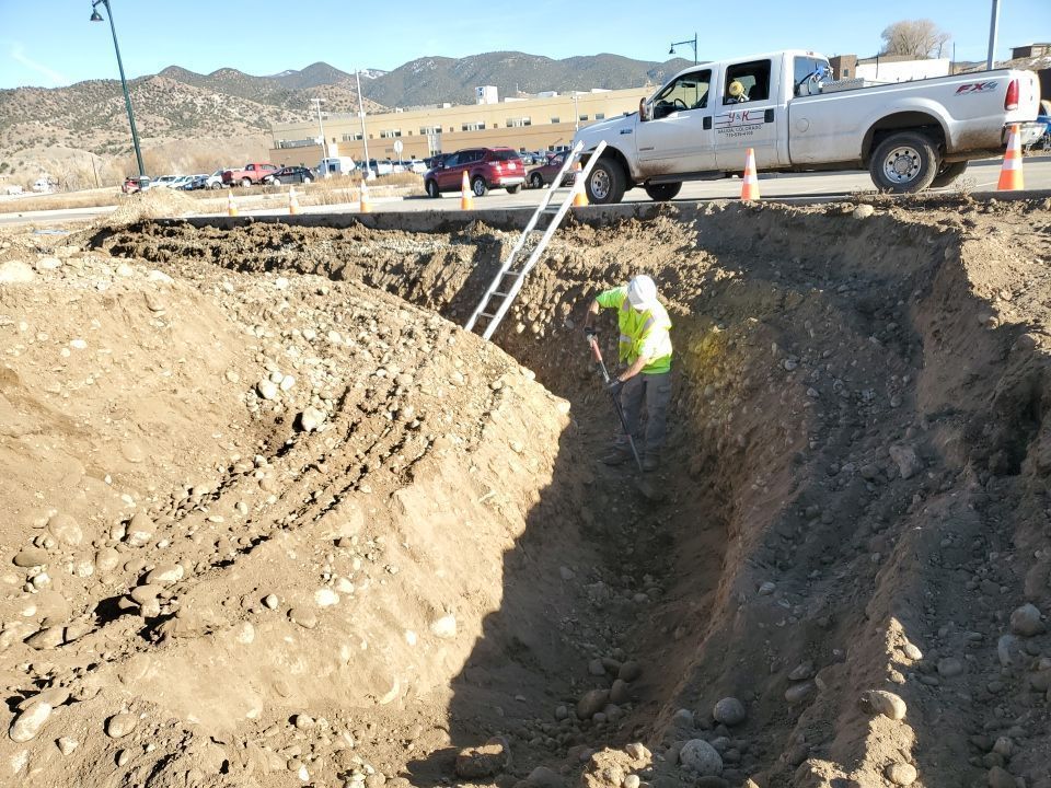 Workers digging out pipeline trench
