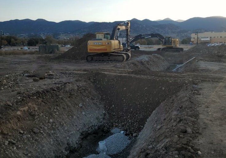 Excavator digging septic system
