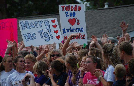 People holding signs that say 