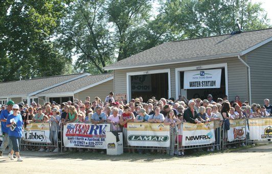 Crowd gathered behind barriers at a 