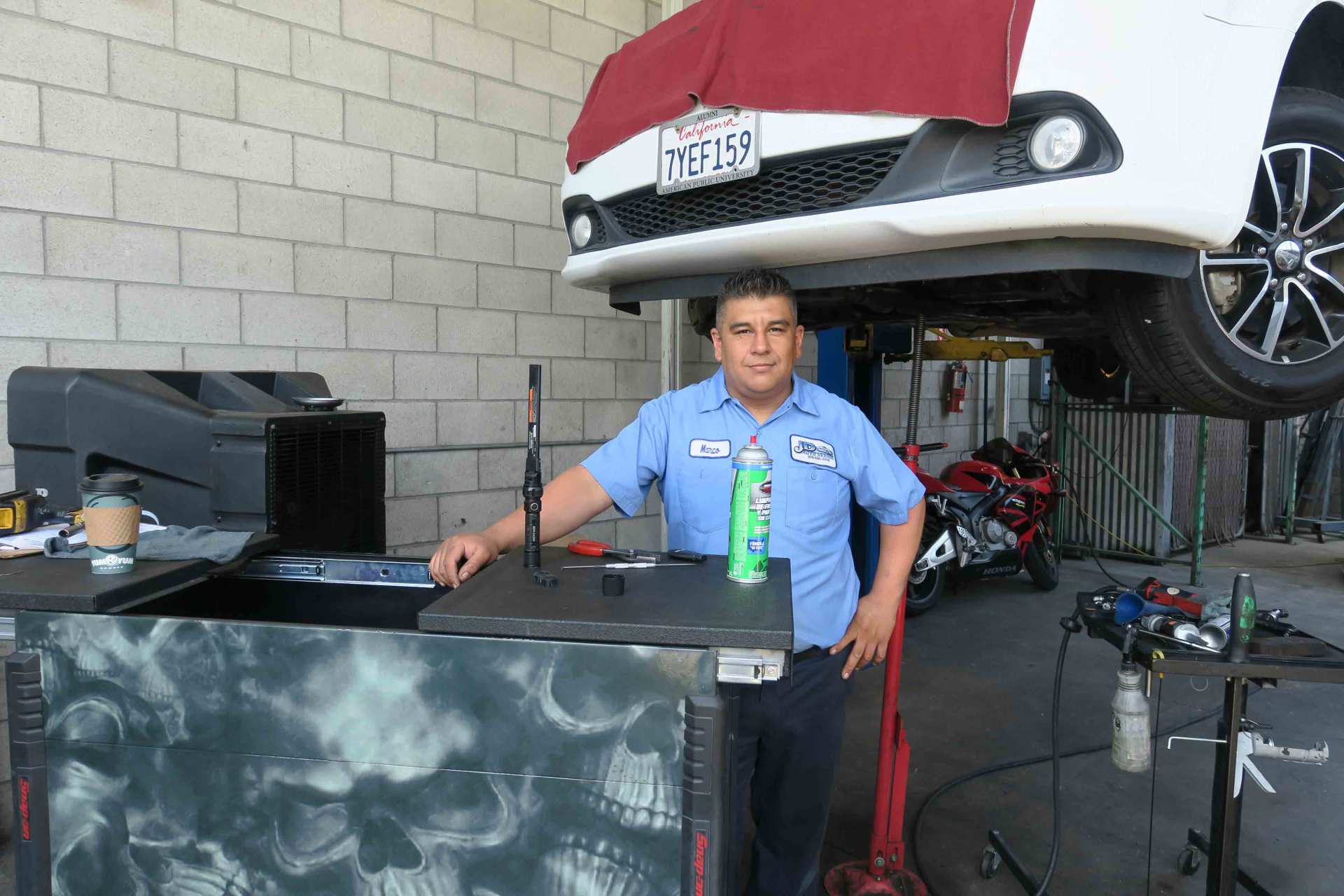 Plugs And Belts — Happy Employee In The Auto Shop in Ontario, California
