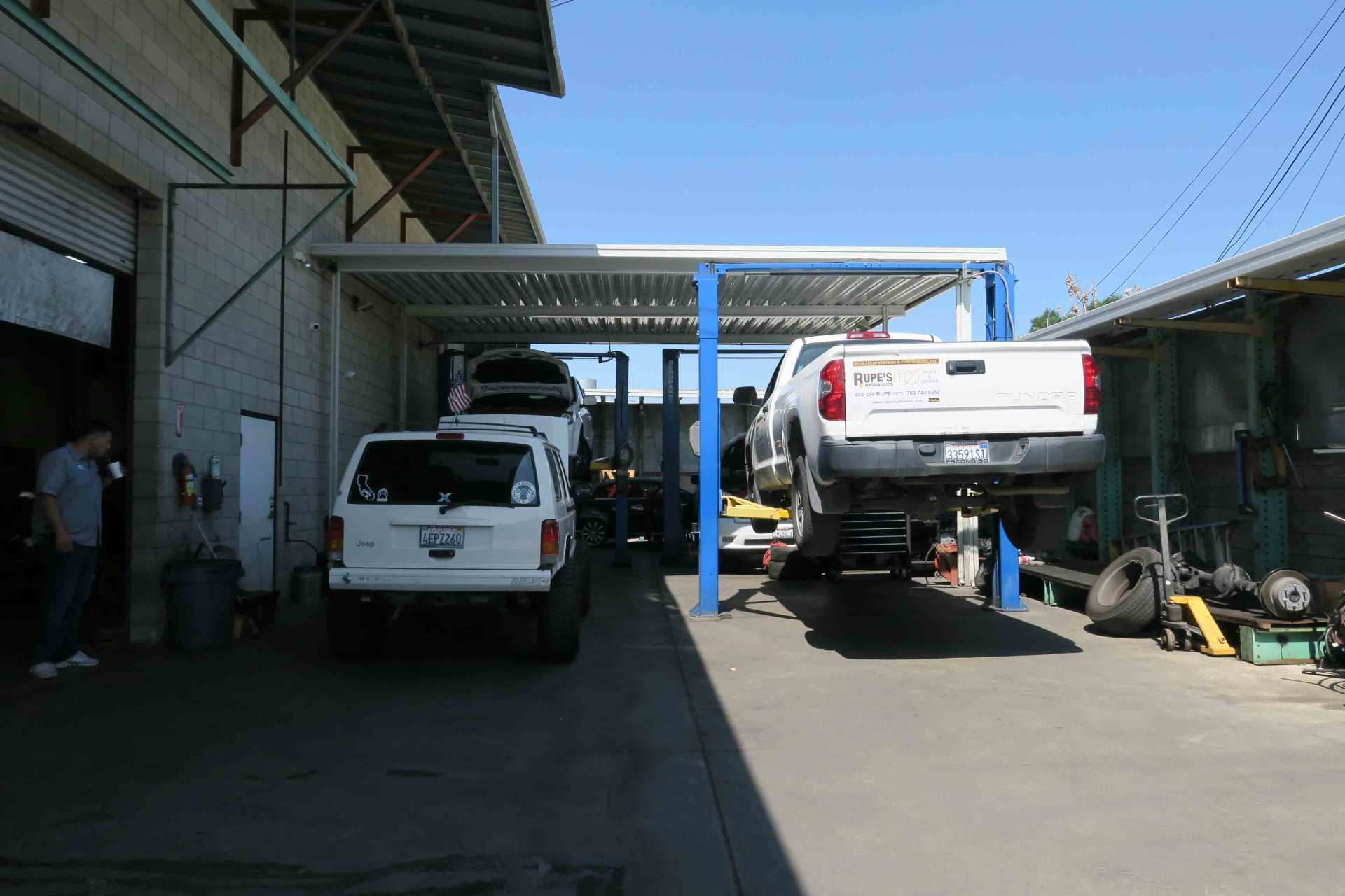 Used Tires — Car Lifted On An Auto Repair Shop in Ontario, California