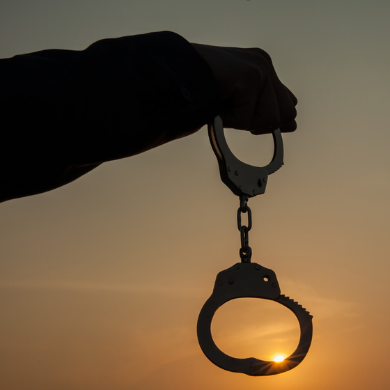 Bail Bonds Near Me — Man Holding Handcuffs in Overland Park, KS Bail Bonds Near Me — Man Holding Handcuffs in Overland Park, KS