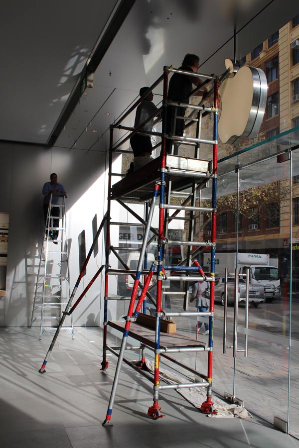 workers designing glass at apple store