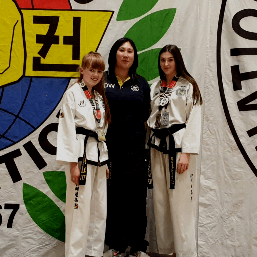 Nuneaton Taekwondo Instructor Danielle Williams with students Bethany Frisby and Ella Barnes