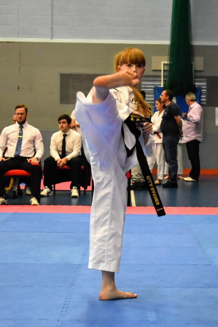 Taekwondo student side kicking