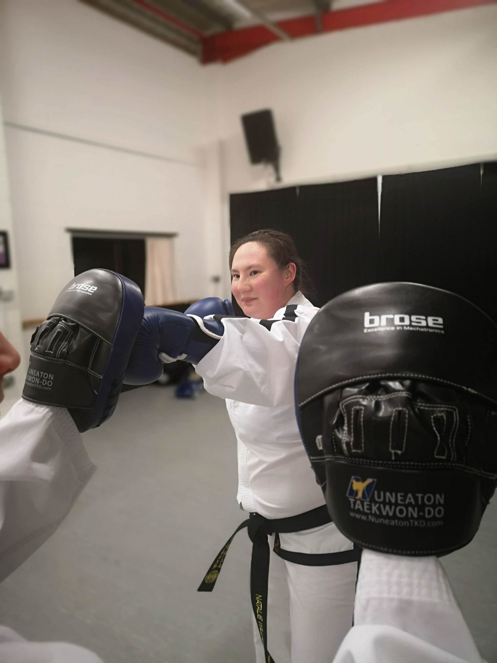 Close up of adult female punching pads