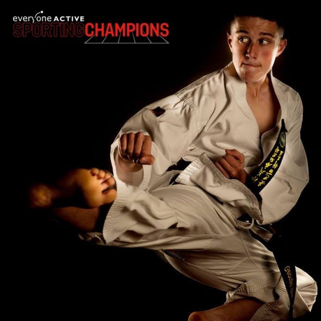 Martial Artist flying side kick on black background