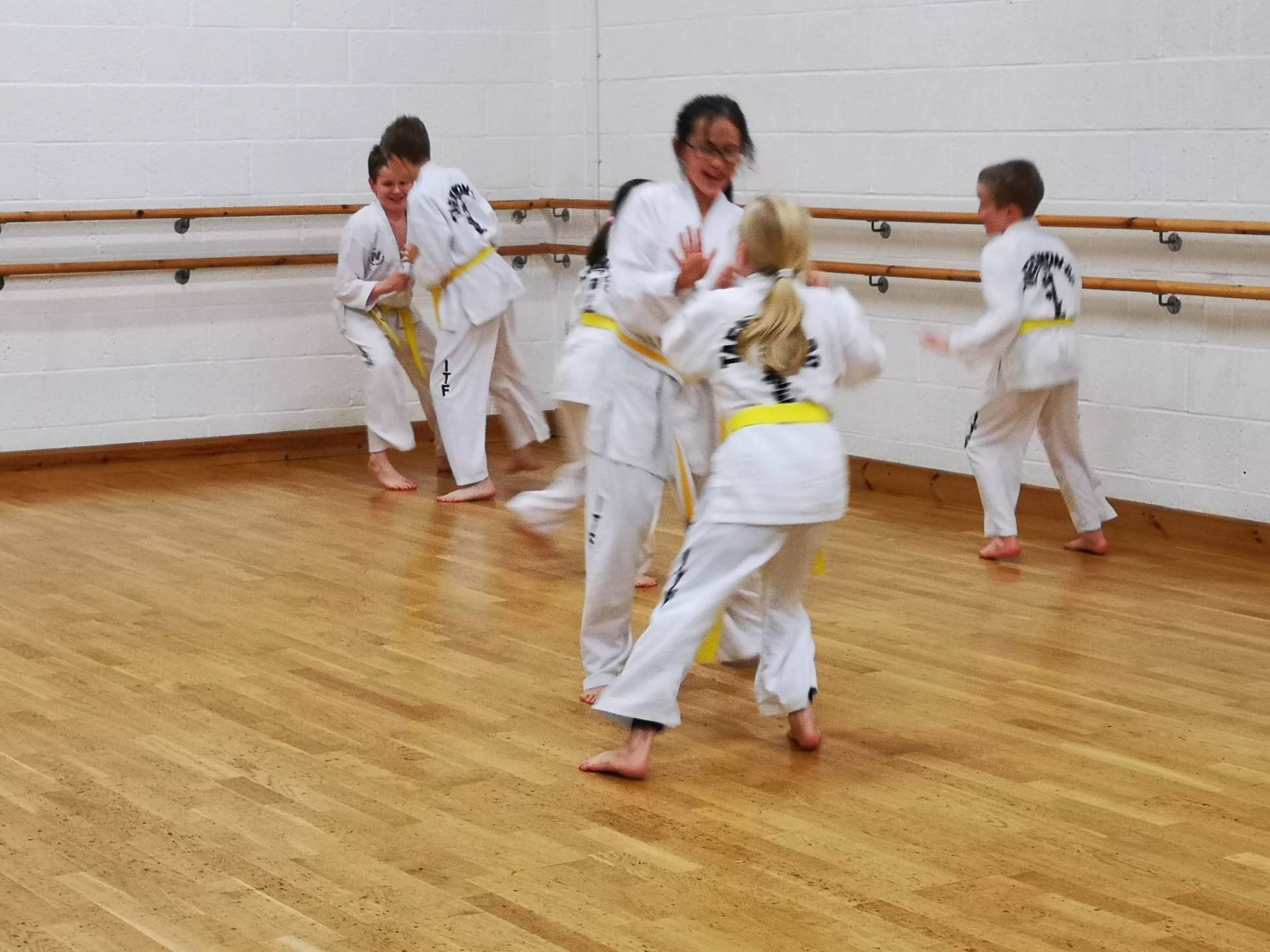 Warm up games in our Wednesday night class Martial Arts students playing tag