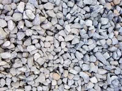 Pile of small light gray rocks or gravel filling the frame