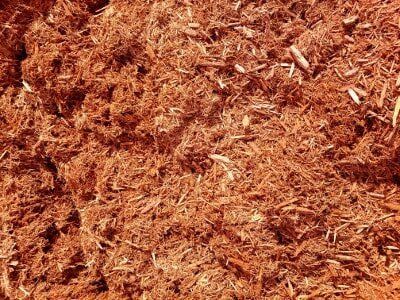 Close-up of reddish-brown wood shavings or mulch texture