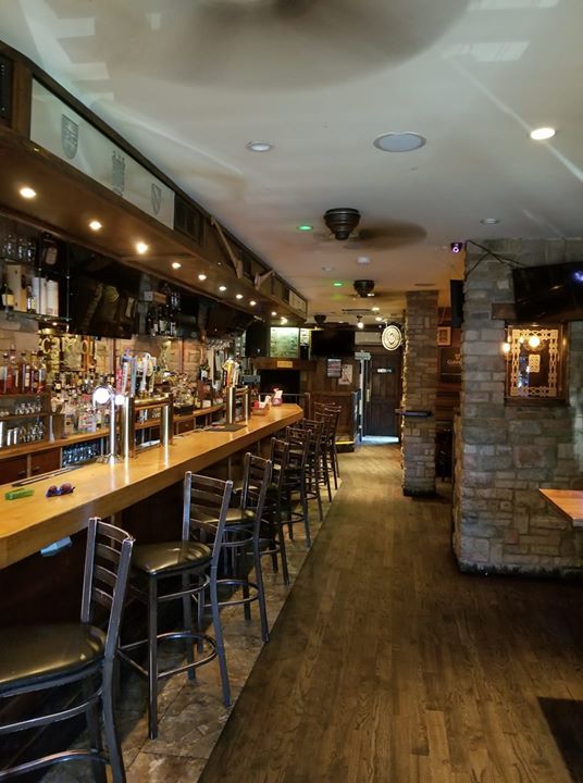 A restaurant with a long bar and stools