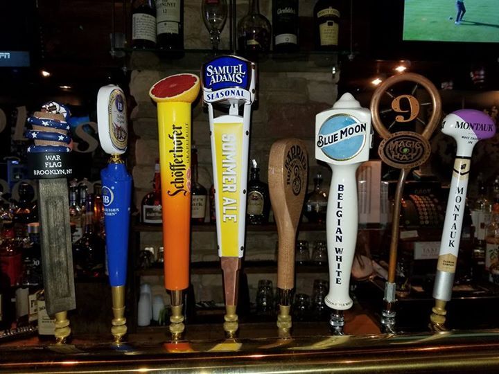 A row of beer taps including one that says blue moon