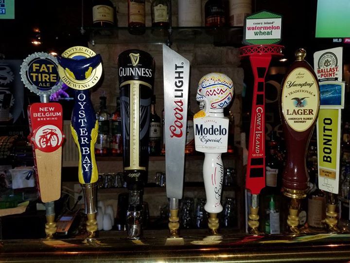 A row of beer taps including coors light and modelo