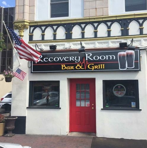 The recovery room bar and grill has a red door