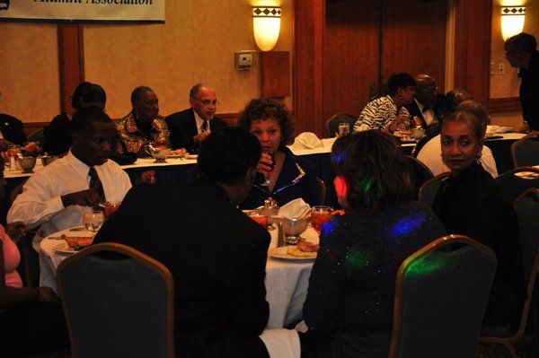 People seated at tables in a banquet hall, attending a conference or event.