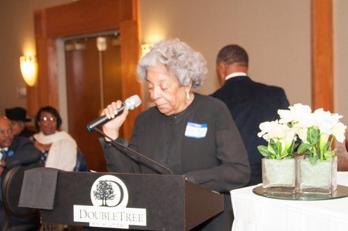 Woman speaking at a DoubleTree podium