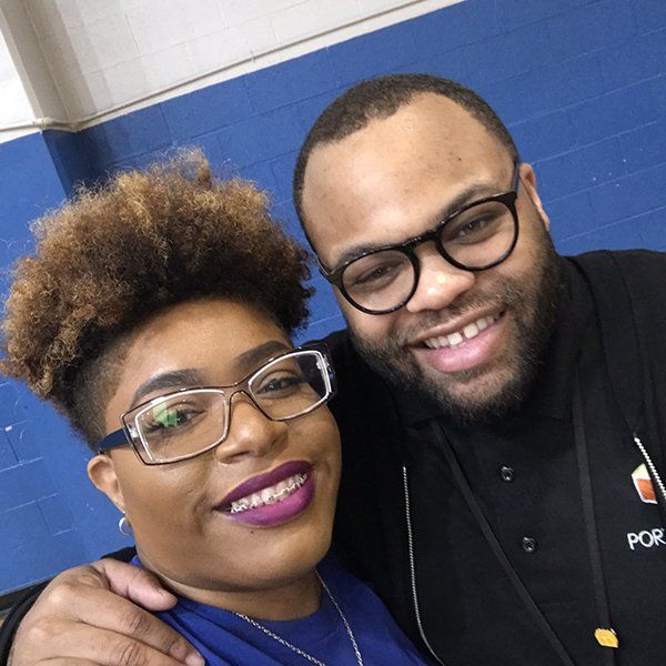 Two people smiling at the camera,