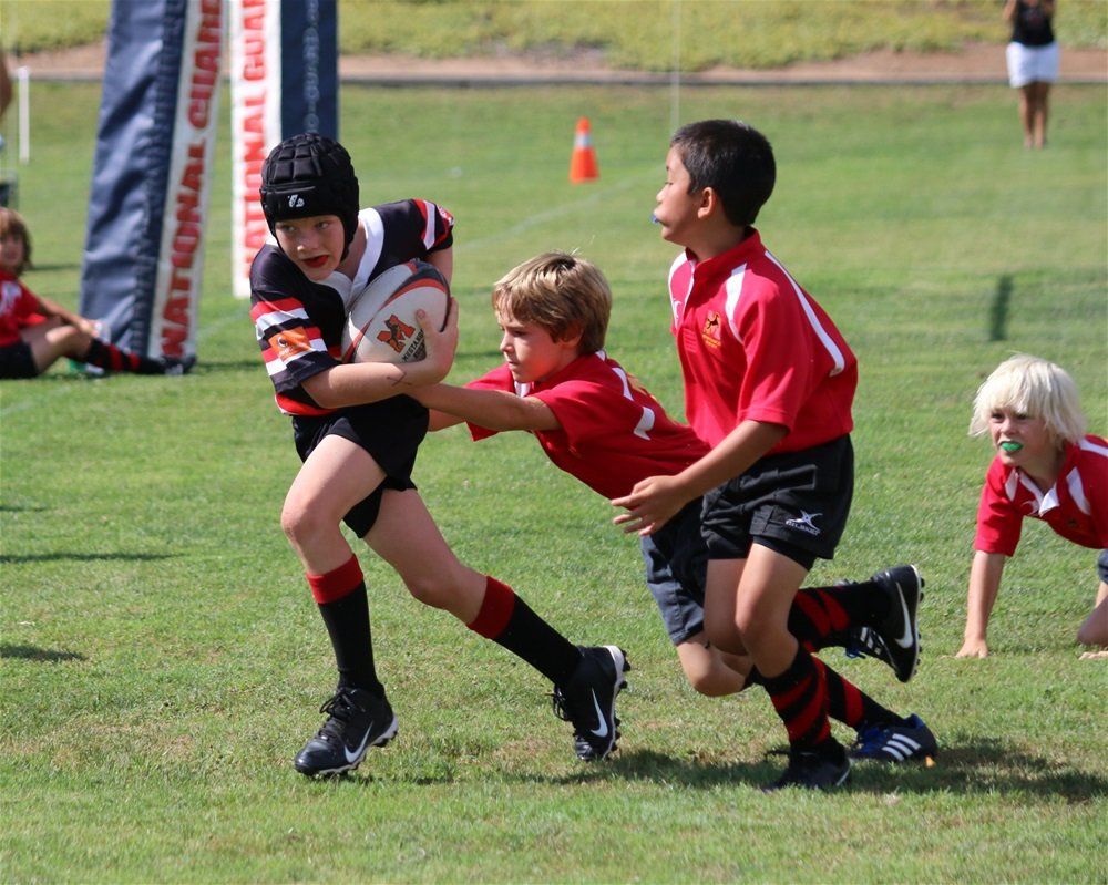 young boys playing rugby