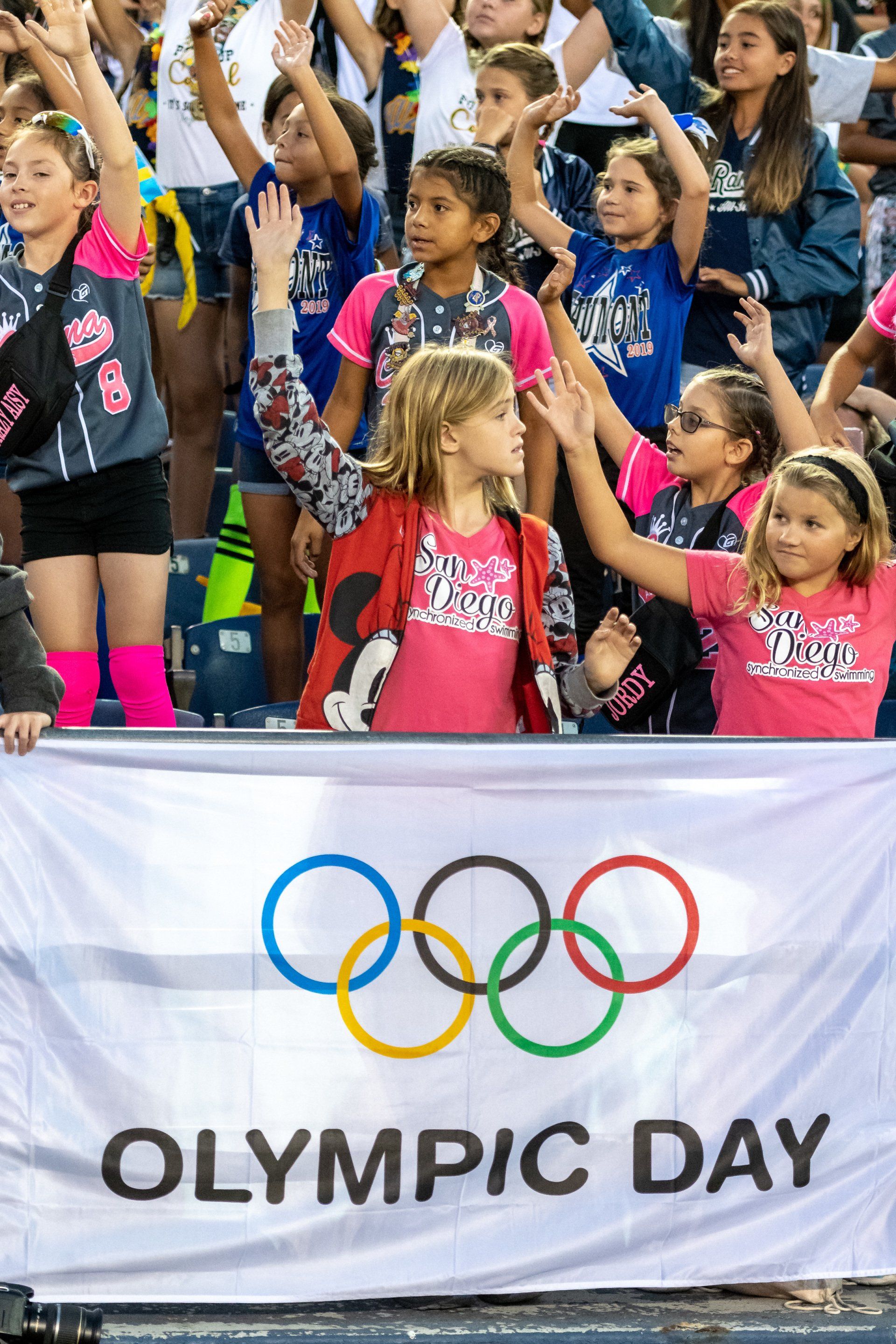 kids in a stadium celebrating at opening games