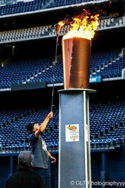 Youth lighting torch at opening ceremonies