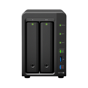 Black two-bay NAS enclosure with green status lights, front USB ports, and power button on a white background