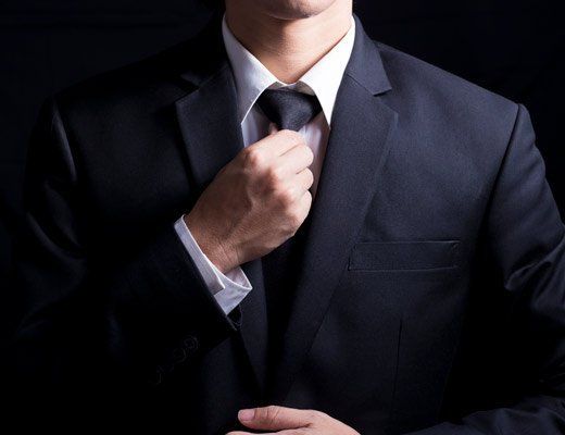 business man adjusting tie