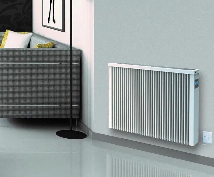 White radiator near a grey sofa