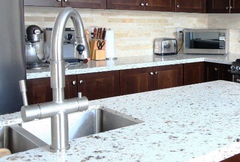 A kitchen with a sink and a stainless steel faucet